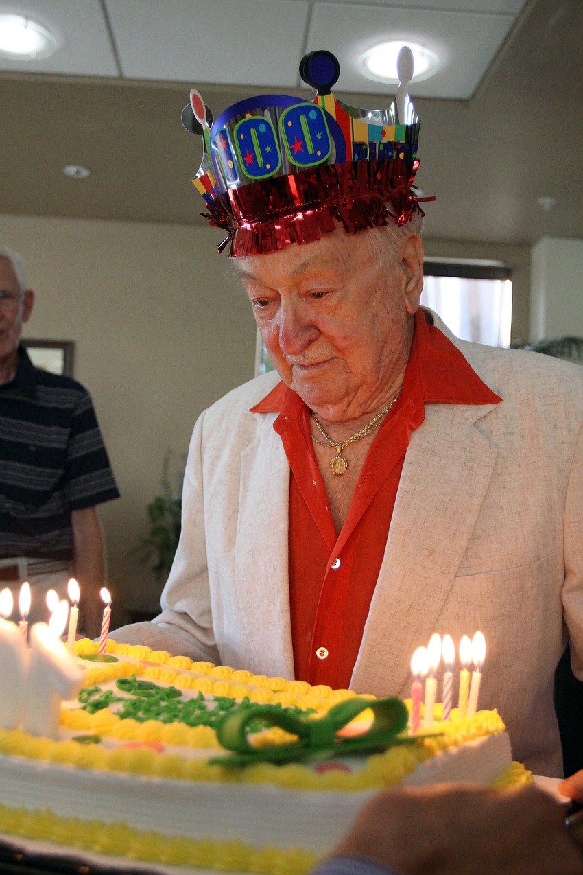 Walter Derdeyn gets ready to blow out the candles on his cake at his 100th birthday party Friday, May 6 at the Regency House.