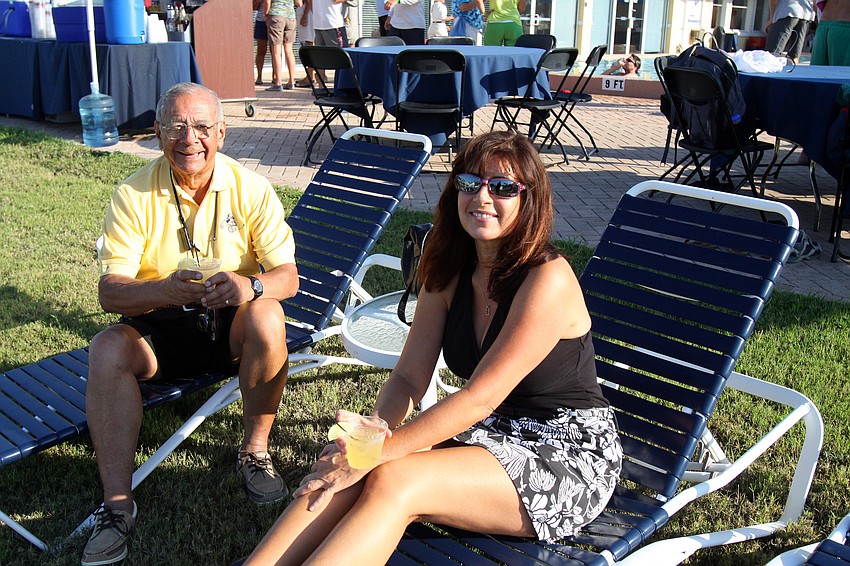 Edward Leon and his daughter Patricia Leon lounge by the pool Saturday, May 7 during the after party for the Sarasota Bay Cup at Bird Key Yacht Club.