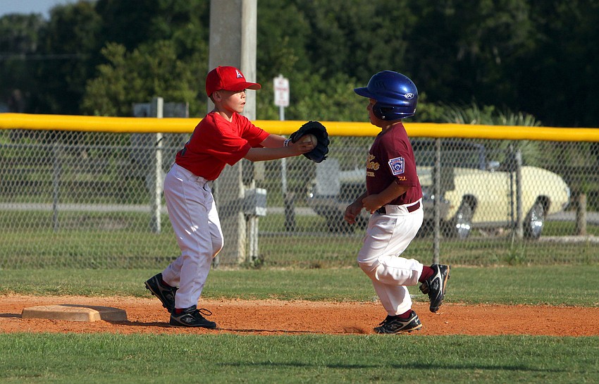 Dominic Cuffaro, #12, tags out Owen Haney, #5, at third during their final game of the Spring season Monday, May 9 at Twin Lakes Park.