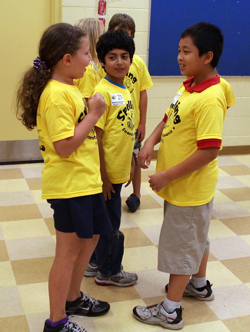 Third graders who made it into the next round talk to one another excitedly at the Sarasota Kiwanis Club's Spelling Bee Friday, May 13 at the Boys and Girls Club.