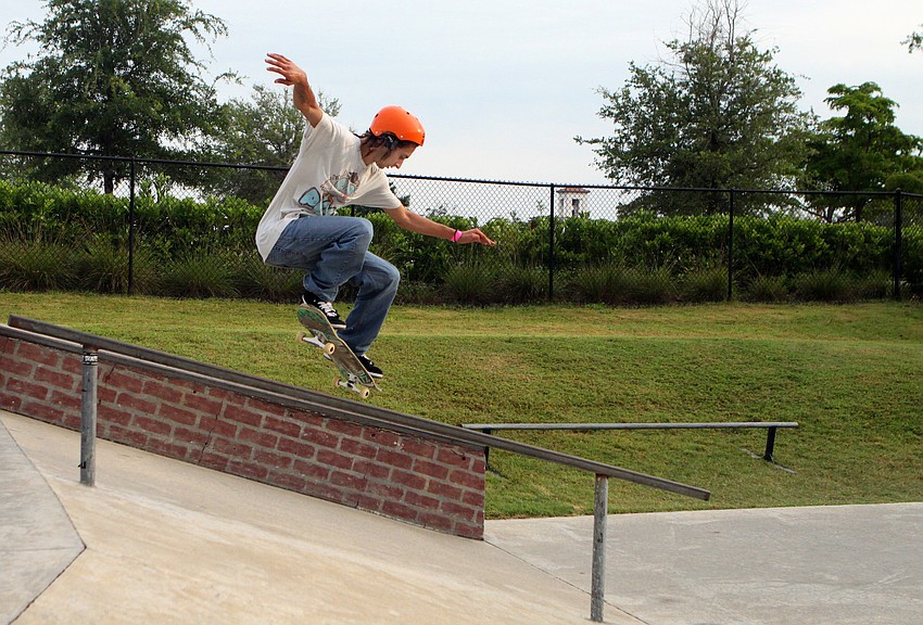James Bixby grinds down the railing Saturday, May 14 during the Golden Era Tour event at Payne Park's skate park.