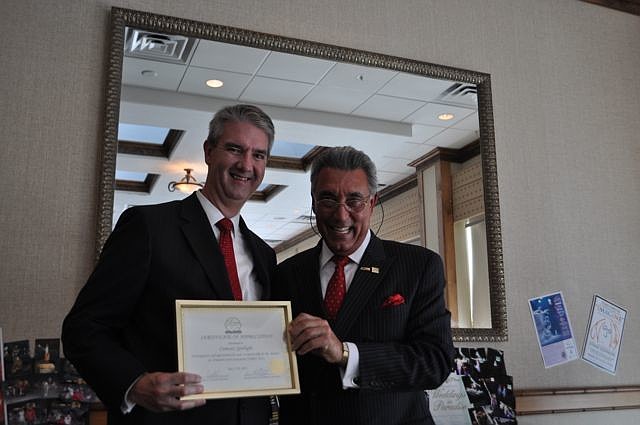 James Maslen, Comcast Spotlight, accepts his award from Andrew Vac.