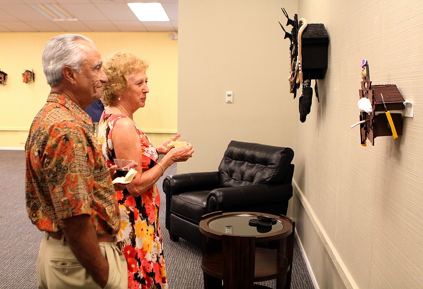 Hal and Anita Andrade look at some Nathan Skiles work at the opening of the RCAD Creatives Exhibition Thursday, May 19 at Longboat Key Center for the Arts.