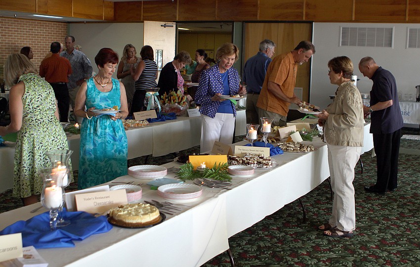 People add different types of desserts to their plates during Family Promises' Third Annual Just Desserts event Friday, May 20 at Selby Garden's Great Room by the Bay.