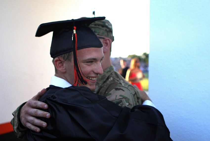 Otto Duerk hugs his brother, Kyle Gempler, who surprised him by coming home from Afghanistan to see Duerk graduate from high school.