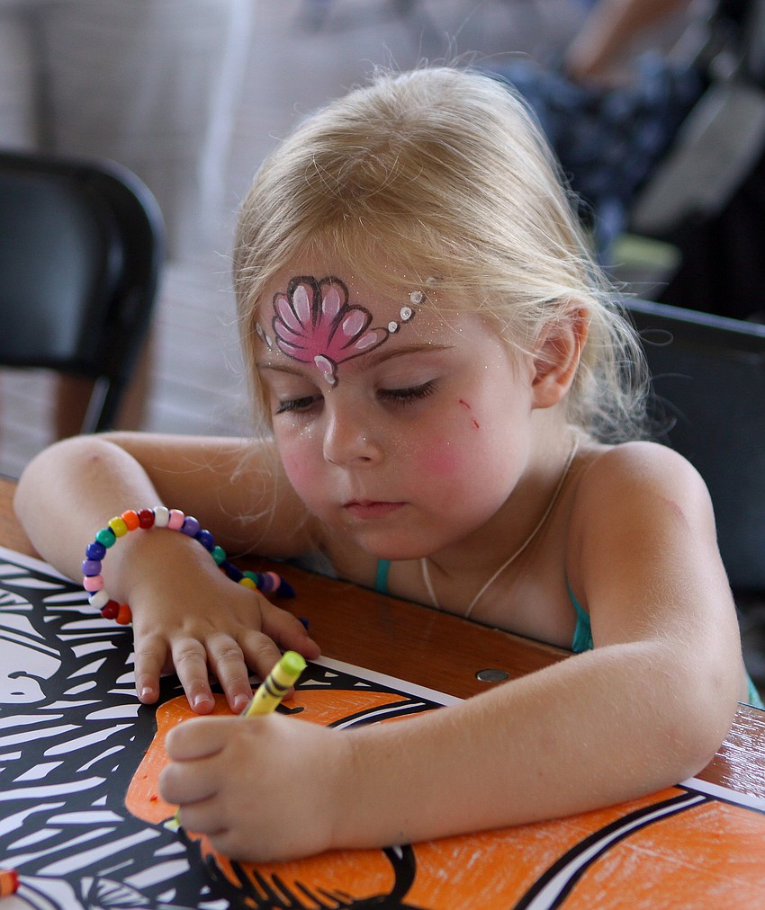 Greer Gaspard, 4, works on coloring in a big clown fish during the World Ocean Day Family Festival Sunday, June 5 at Mote Aquarium.