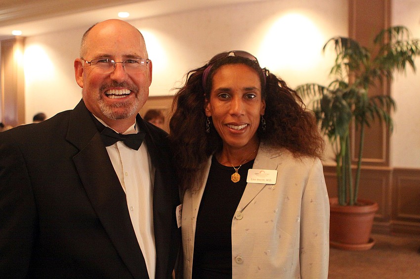 Emcee John Gearhardt and Lisa Merritt, M.D.