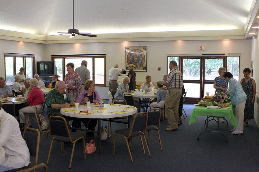 People enjoy sitting together and catching up after the church service Sunday, June 5 during the All Angels brunch.