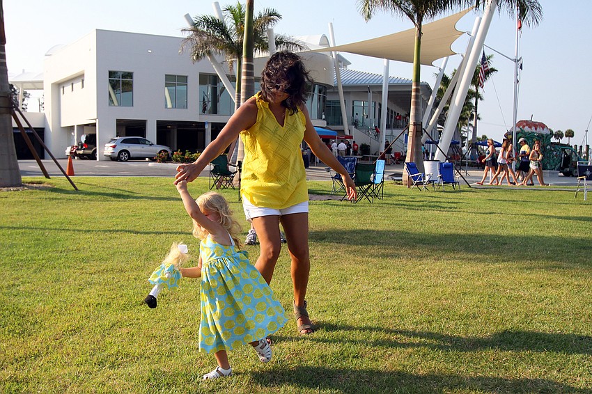 Farah Bersch spins her daughter, Frankie, around while Soul R Coaster played during the Sarasota Yacht Club's 1st ever Concert on the Lawn event Saturday, June 11 at the Sarasota Yacht Club.