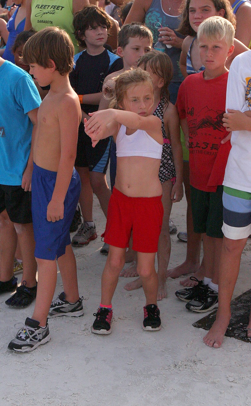 Maura Ryan stretches out before the 1-mile fun run Tuesday, June 14 on Siesta Key Beach.