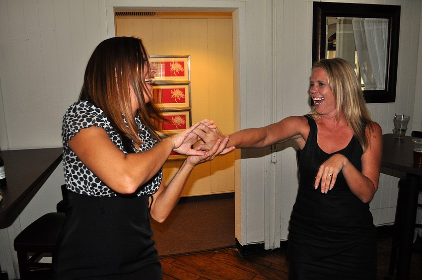 Michelle Ryan and Kim Phillips dance to some music Friday, June 17 at the wrap party following the YPG Annual Conference/SUM+ at the Hyatt Regency Sarasota's Boathouse.