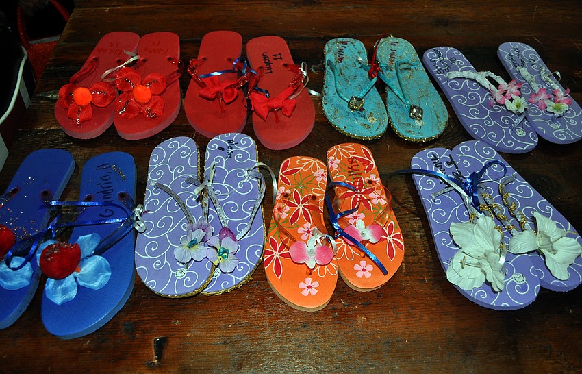 Fashionable flip flops made by girls who are participating in Girls Inc.Credible at Girls Inc. were for sale Saturday, June 25 inside Stitch Boutique, one of the five stores on Main Street that the girls got to try and sell their creations.