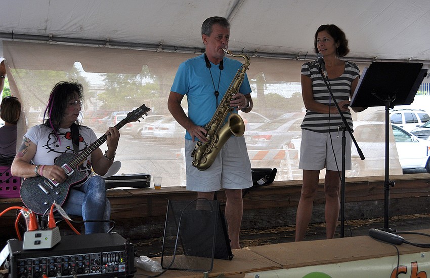 2 Saxy performed under the tent during the Sarasota Farmers Market first ever Shrimp and Lobster Festival.