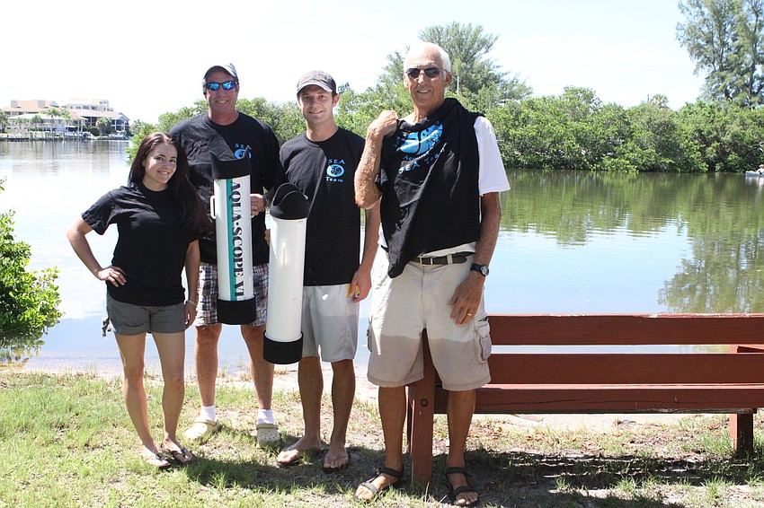 Amanda Dominguez, Steve Harris, Chris Wetzig and Bob Clousson model their seagrass team shirts Saturday, July 30 out by the water at the Turtle Beach Community Center