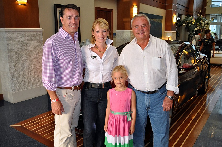 Nigel and Nathalie Mould, Josie Jorgensen, 5, and Ken Dâ€™Agostino pose in front of the Tesla Model S.