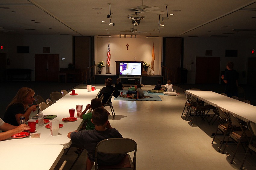 Families enjoy Family Fun Movie Night Friday, Aug. 26 in the Parish Hall.