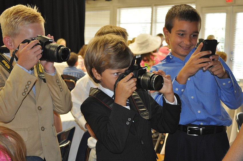 Ty Laird, Hayden Bizick and Grant Massey take photos of the moms.