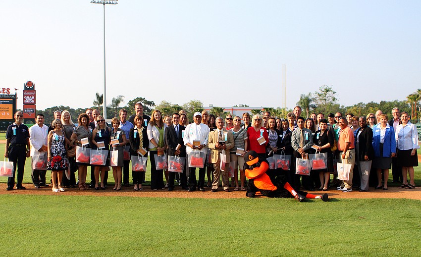 The record number of nominees pose on the field with The Bird at the 2011 National Tourism Week Awards ceremony Thursday, May 12, at Ed Smith Stadium.