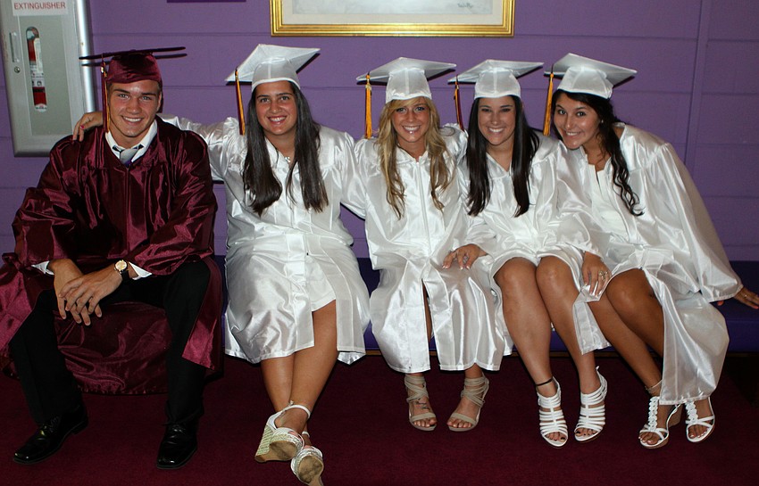 Cody Tope, Kiley Pritchard, Sam Byrd, Jill Bouziane and Katie Quintero sit on a bench while waiting to head up stairs to graduate Friday, May 27 at the Van Wezel Performing Arts Hall.