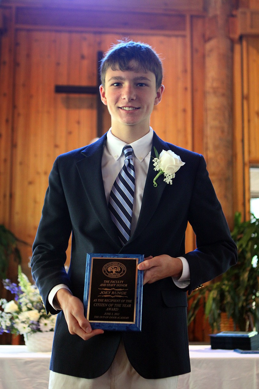 Joseph Runge shows off his Citizen of the Year Award Friday.
