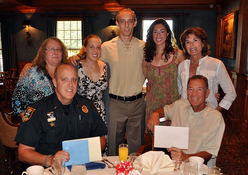 Sarah Kost, Rachel Kost, Ben Kost, Melissa Ruffalo and Barbara Ruffalo stand behind Lt. John Kost and Dr. Donald Ruffalo at the Father's Day Brunch Sunday, June 19 at the Oaks Club.