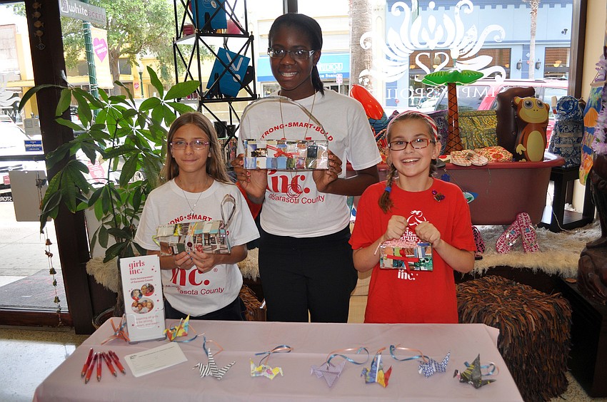 Dylane DeStasio, 13, Jasmine Ward, 13, and McLain Miller, 9, hold up the magazine purses Saturday, June 25 inside Simply Spoiled.