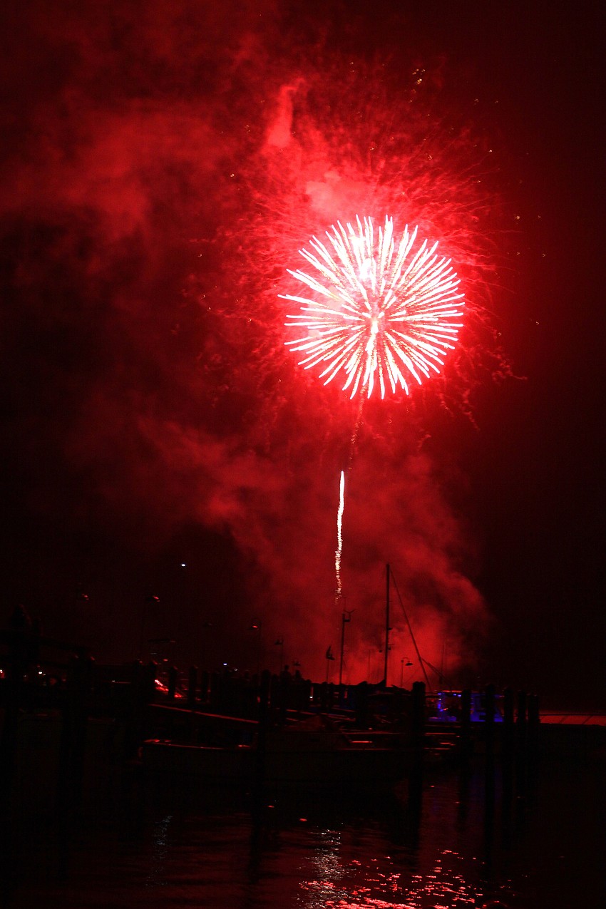 A red firework lit up the dock and the Sarasota Bay during the fireworks display.