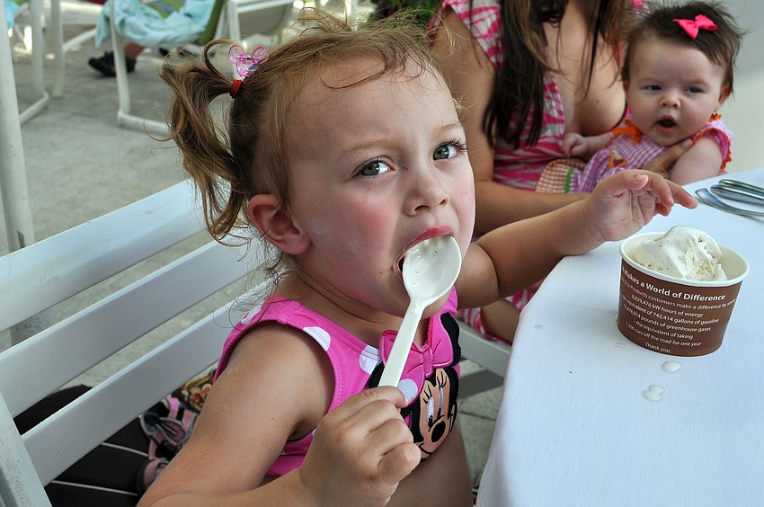 Ellie Ewing, 2 1/2, tries to get as much vanilla ice cream in her mouth at the Lobster BBQ Sunday, July 3 at the Longboat Key Club Resort.