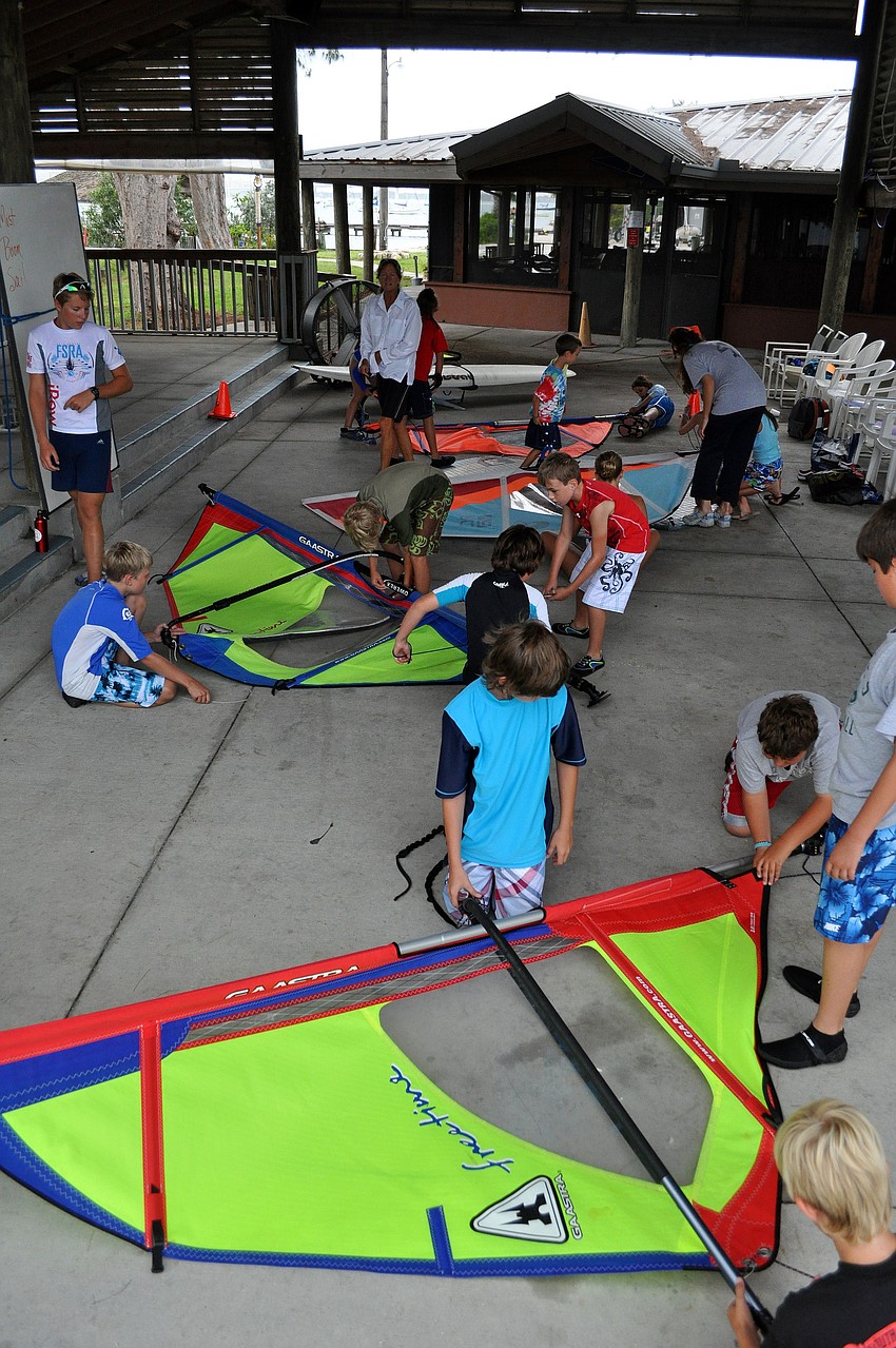 The campers try to disassemble their sails faster than the other groups Friday, July 8 during the Island Style Water Sports Camp.