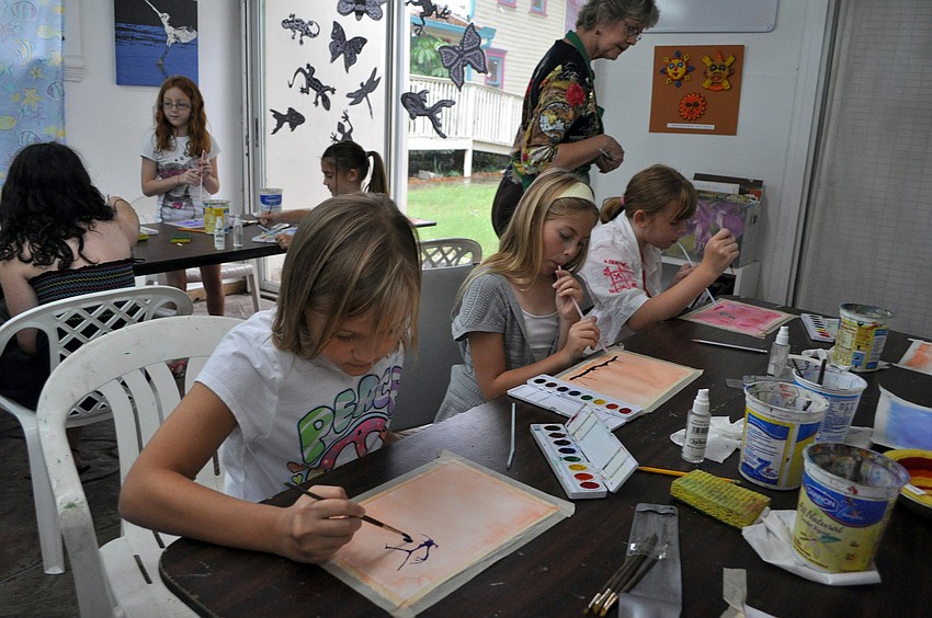 The class works on creating their tree paintings on the final day of class Friday, July 8 at the Art and Photography Studio of Colleen Cassidy.