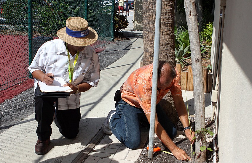 Ervin Shannon waits to hear what the exact measurement of the cotton plant is from Mark Meador Friday, July 15 at Casa del Mar.