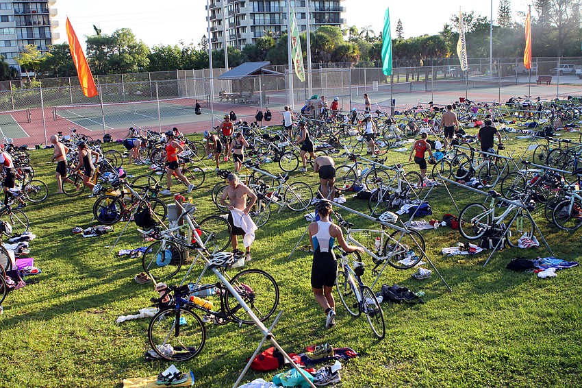 Participants quickly make the transition from swimming to biking during the Siesta Key Triathlon Saturday, July 23 out at Siesta Key Public Beach.