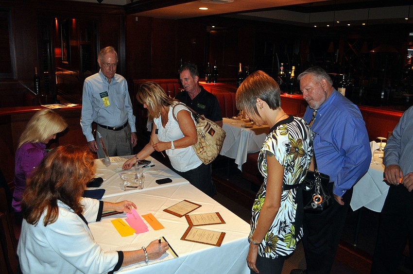 People sign in and chose what they want for lunch dish Thursday, July 28 at Fleming's.