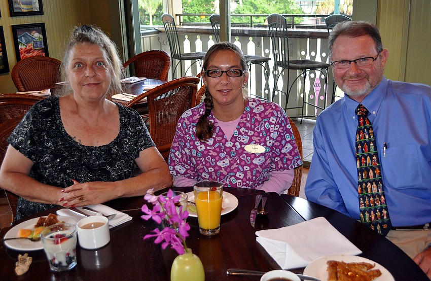 Sharon Sullivan, Laura Moyer and Mike Mackenzie sit together and enjoy their breakfast Tuesday, Aug., 16 at Tommy Bahama Restaurant.