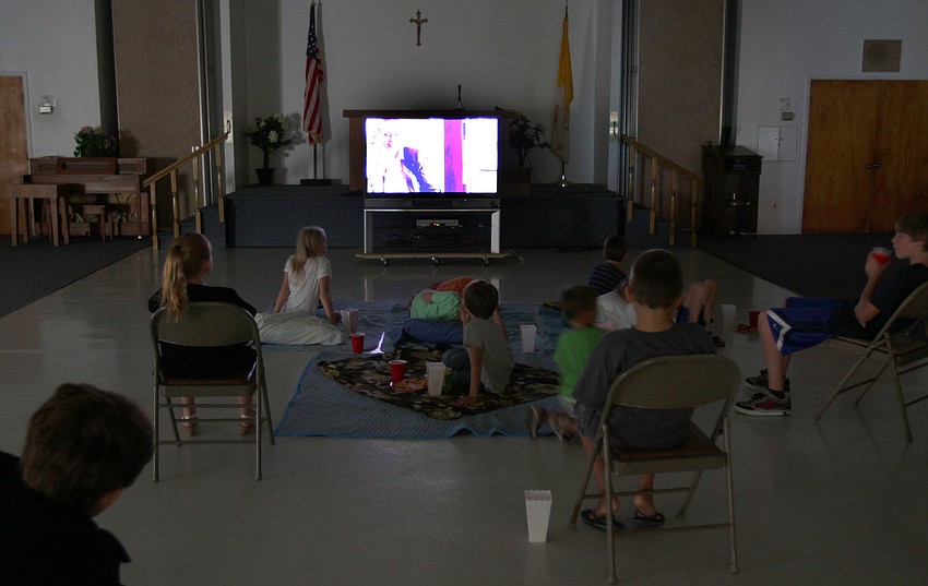 The kids spread out on blankets and chairs to watch Marley: The Puppy Years during Family Fun Movie Night Friday, Aug. 26 in the Parish Hall.