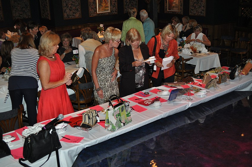 Guests checking out the silent auction of bags and baubles