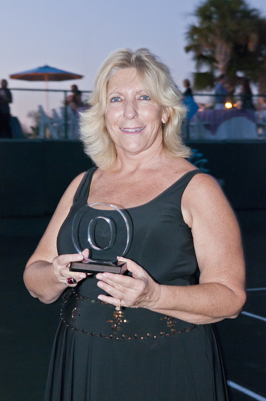 Carol Butera accepting standout couple award for John and Elenor Maxheim