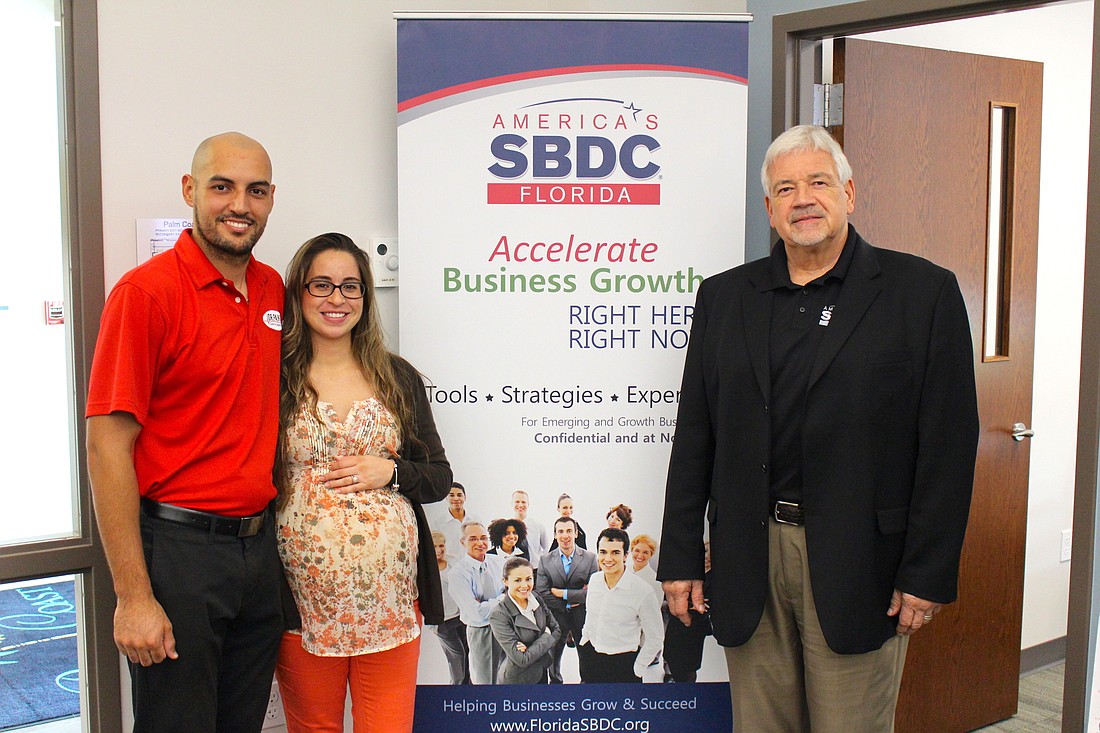 Palm Coast BAC Area Manager Ray Peter, right, has helped Omar and Katherine Rivera establish their business for success. Photo courtesy of the city of Palm Coast