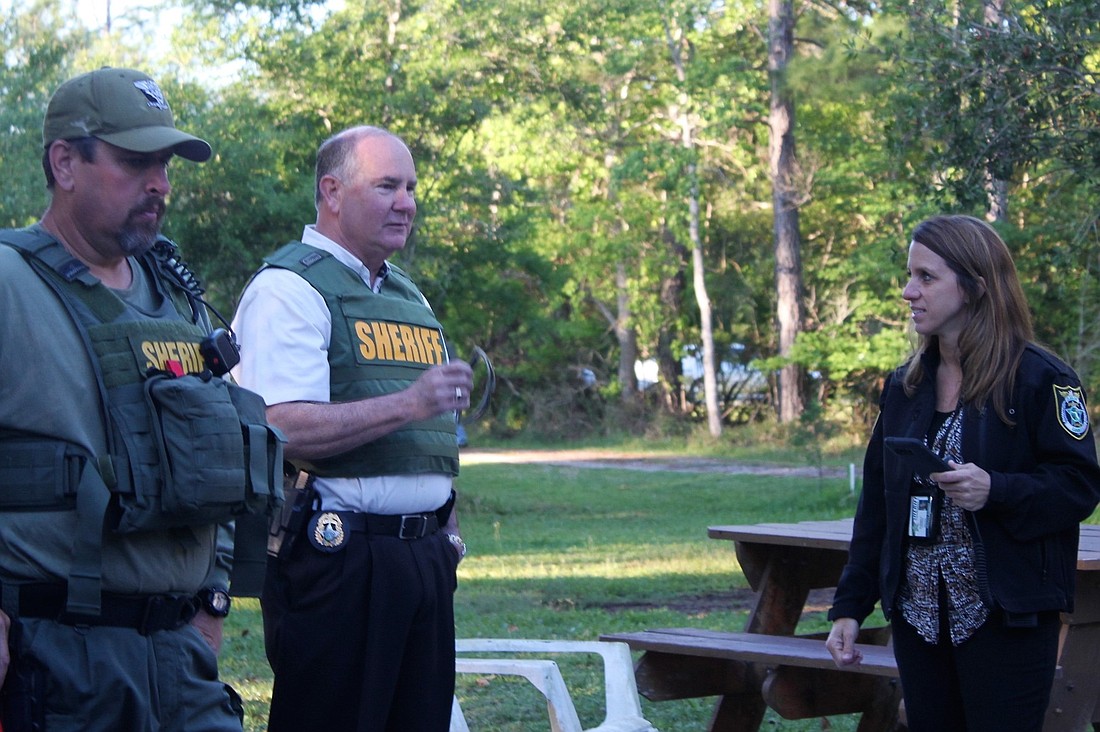 Sheriff Staly, center, with deputies and detectives at the property of Charles William Singer. (Photo courtesy of the Flagler County Sheriff'  s Office)