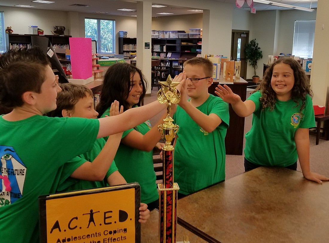 From left to right, the A.C.T.E.D. team celebrate their victory: Jack Gilvary, Grant McMillan, Josefine D'   Elia, Zachary Bennett, and Chloe Long. Photo by Colleen Michele Jones.