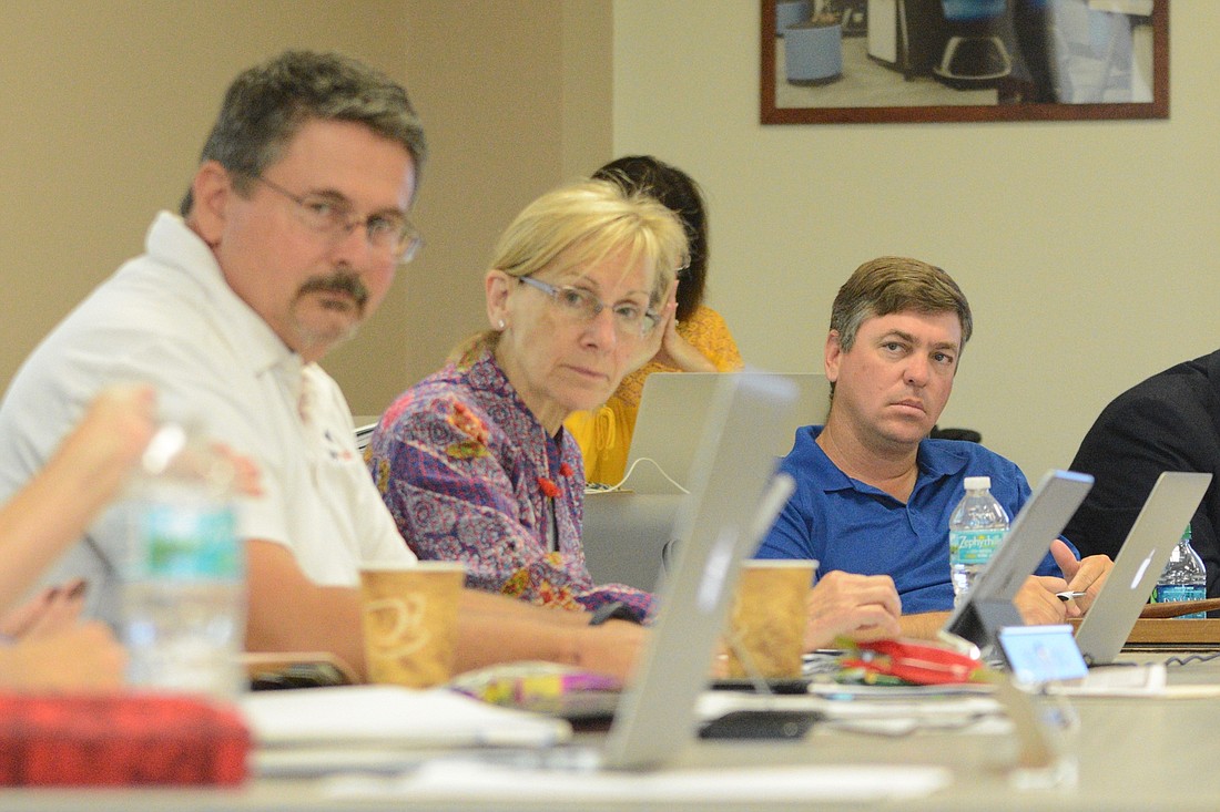 School Board Chairman Trevor Tucker listens during a board workshop May 2. Board members Andy Dance and Janet McDonald are at left. (Photo by Jonathan Simmons)