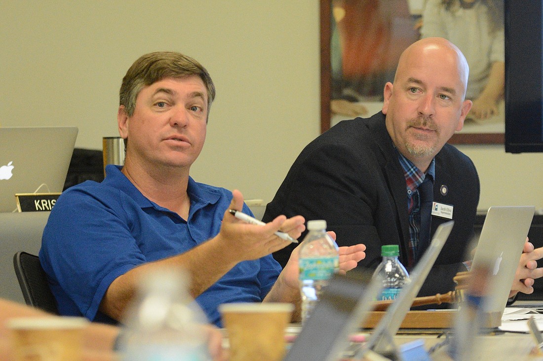 School Board Chairman Trevor Tucker, left, talks during a board workshop. Superintendent Jacob Oliva is at right. (Photo by Jonathan Simmons)
