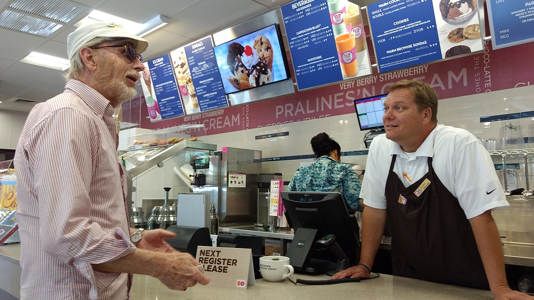 Customer Larry Lewis orders food from Manager Gary Cox. Photos by Brian McMillan