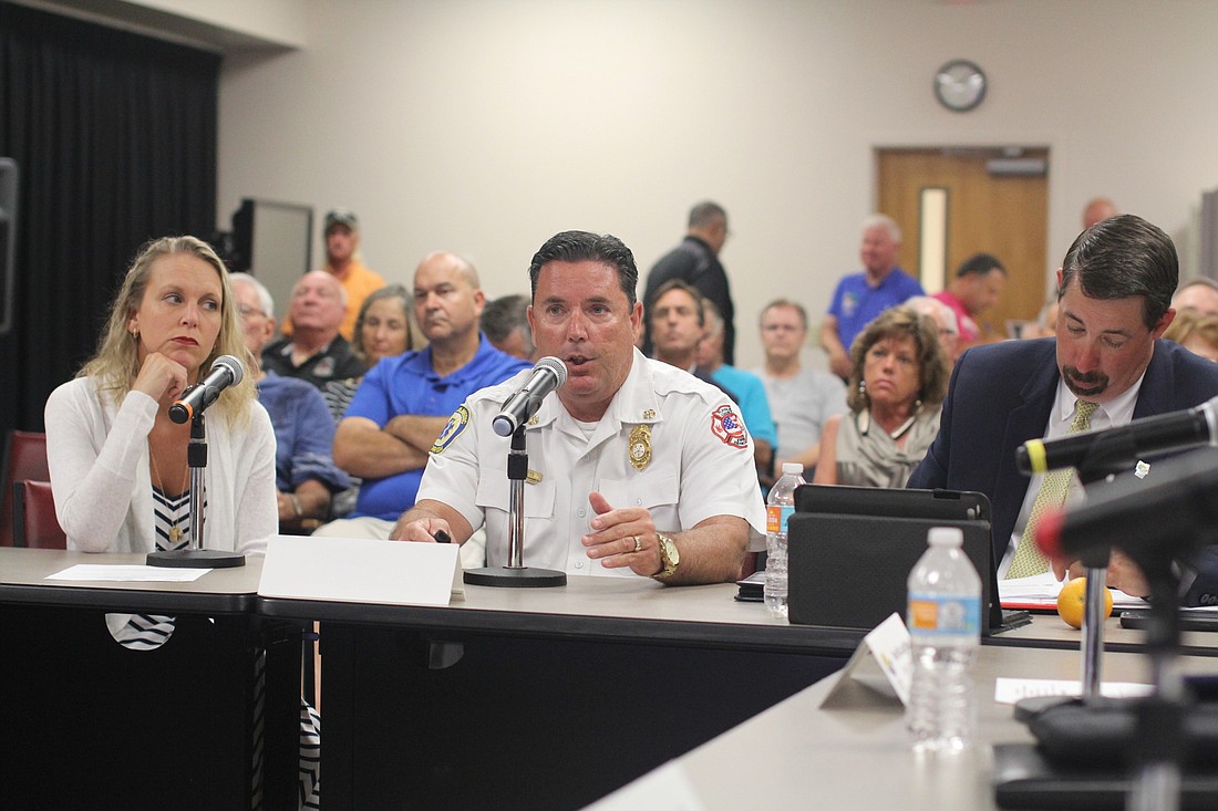 Dr. Kristin McCabe, EMS Medical Director; and Don Petito, chief, Fire Rescue; make a presentation on the Community Paramedicine program at a Board of County Commissioners workshop. At right is County Administrator Craig Coffey.