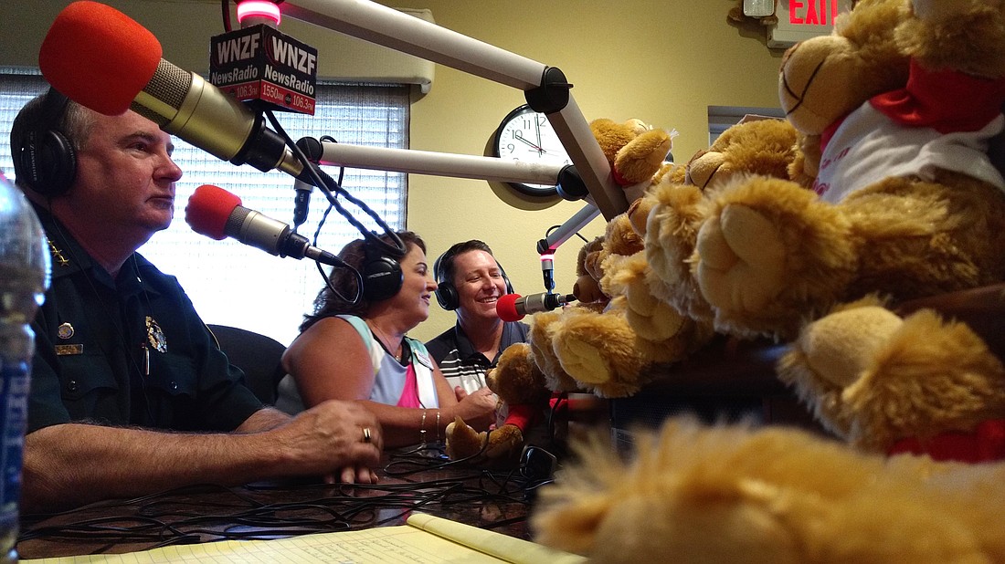 Sheriff Rick Staly accepts a donation of teddy bears from Lisa and Tim Hogan, of State Farm. Photo by Brian McMillan