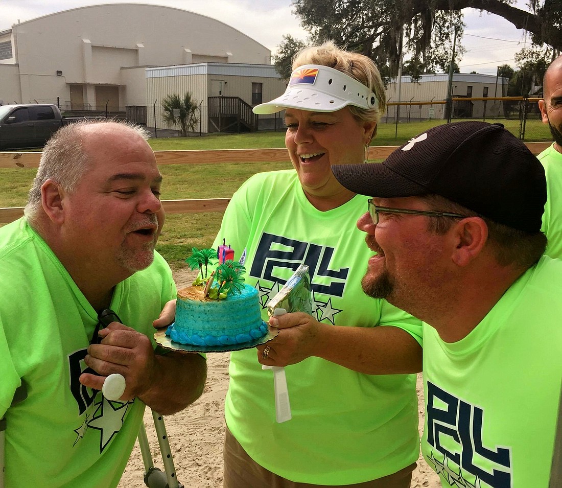 Cindy and Eric Trawick present Keith Stuart with a birthday cake at the little league game. Photo courtesy of Carrie Stuart