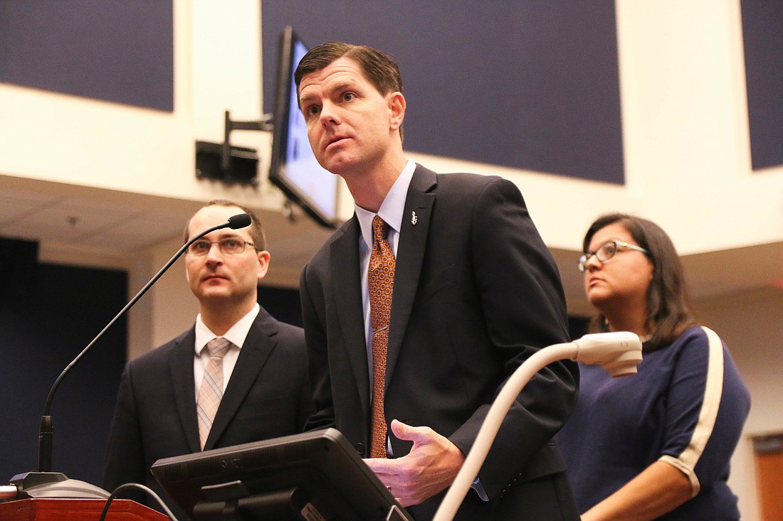 Dr. Brian Marchman, assistant provost and director of distance learning at UF, speaks to the School Board with Andrea Van Denend (left) and Litza Echeverria Rubio (right). Photo by Paige Wilson