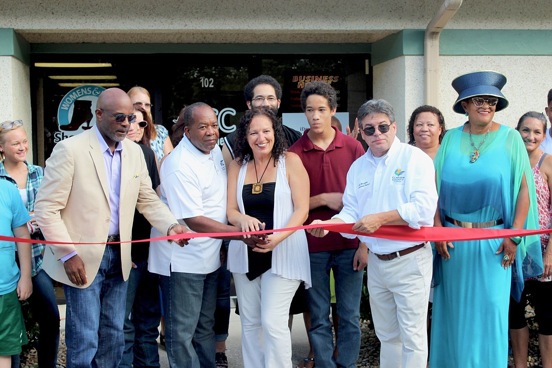 Friends, family and customers joined together to celebrate the grand opening of TCC Dry Cleaners in a ribbon cutting ceremony hosted by the African American Entrepreneurs Club. Photo by Ray Boone