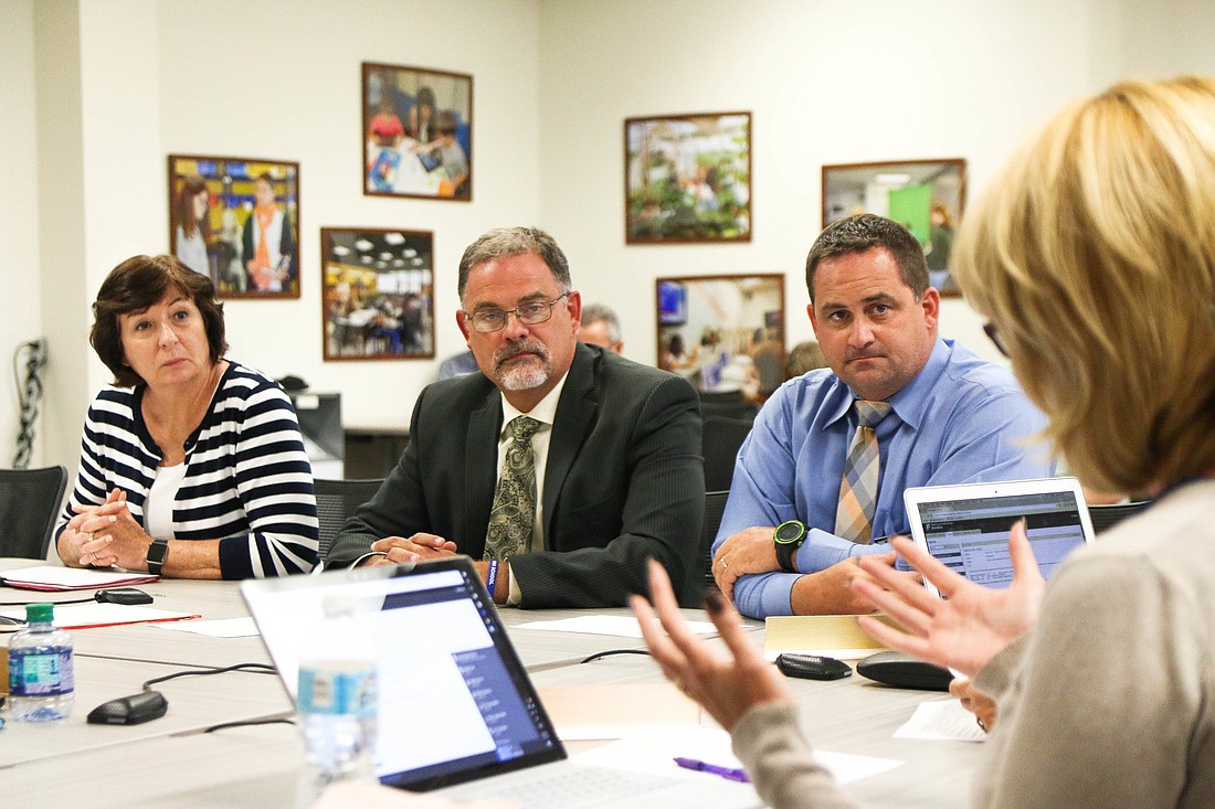 Flagler Schools Curriculum Director Diane Dyer, FPC Principal Dusty Sims (right) and Matanzas Principal Jeff Reaves (middle) discuss options for the UF dual-enrollment opportunity with the Board. Photo by Paige Wilson
