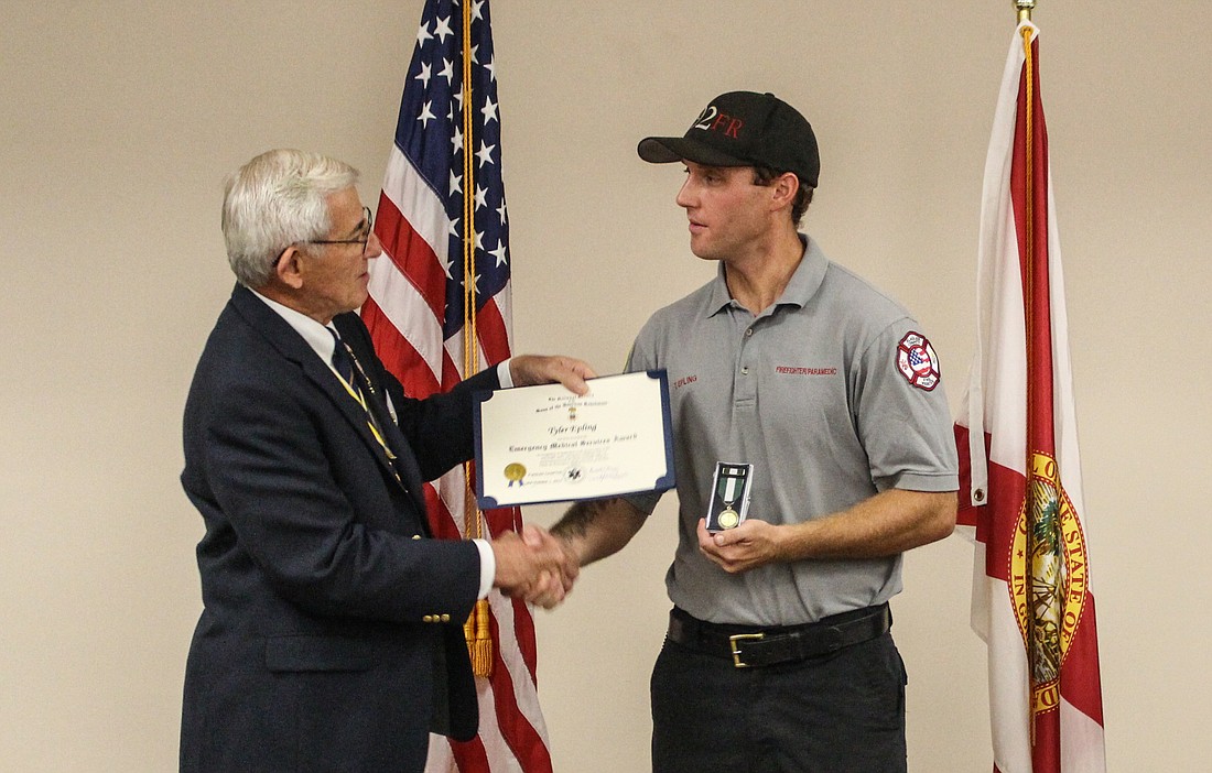 Flagler Chapter President Randall Morris presents Ty Epling with the Emergency Medical Services Award. Photo courtesy of Julie Murphy, Flagler County PIO